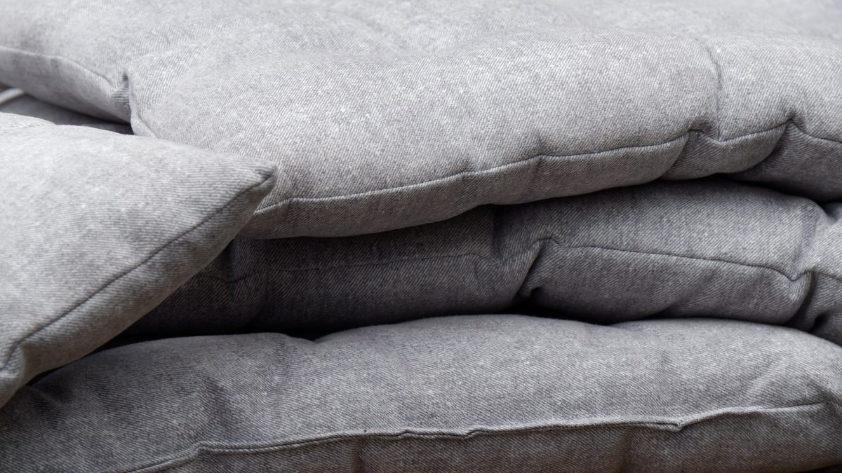 a pile of pillows sitting on top of a wooden table